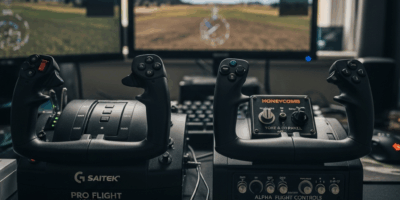 Flight simulator yoke controllers on desk Logitech and Honeycomb side by side