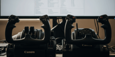 two flight simulator yokes side by side on desk with monitor 20260331 205954